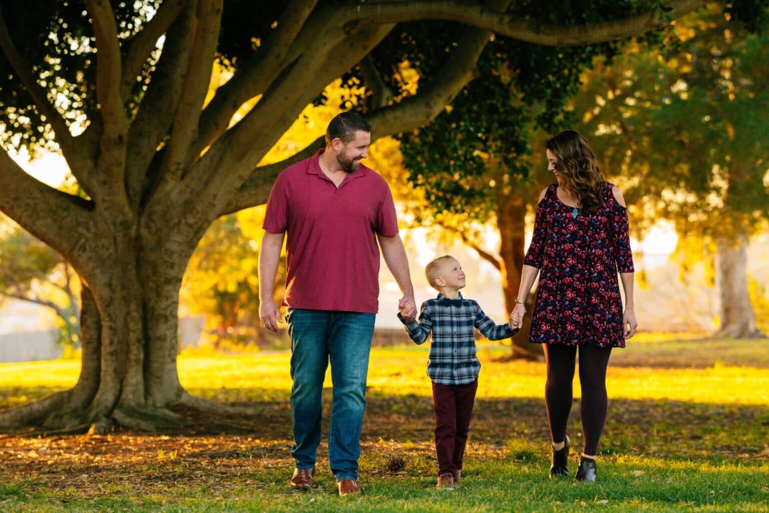 Happy family walking outdoors during sunset, capturing joyful moments.